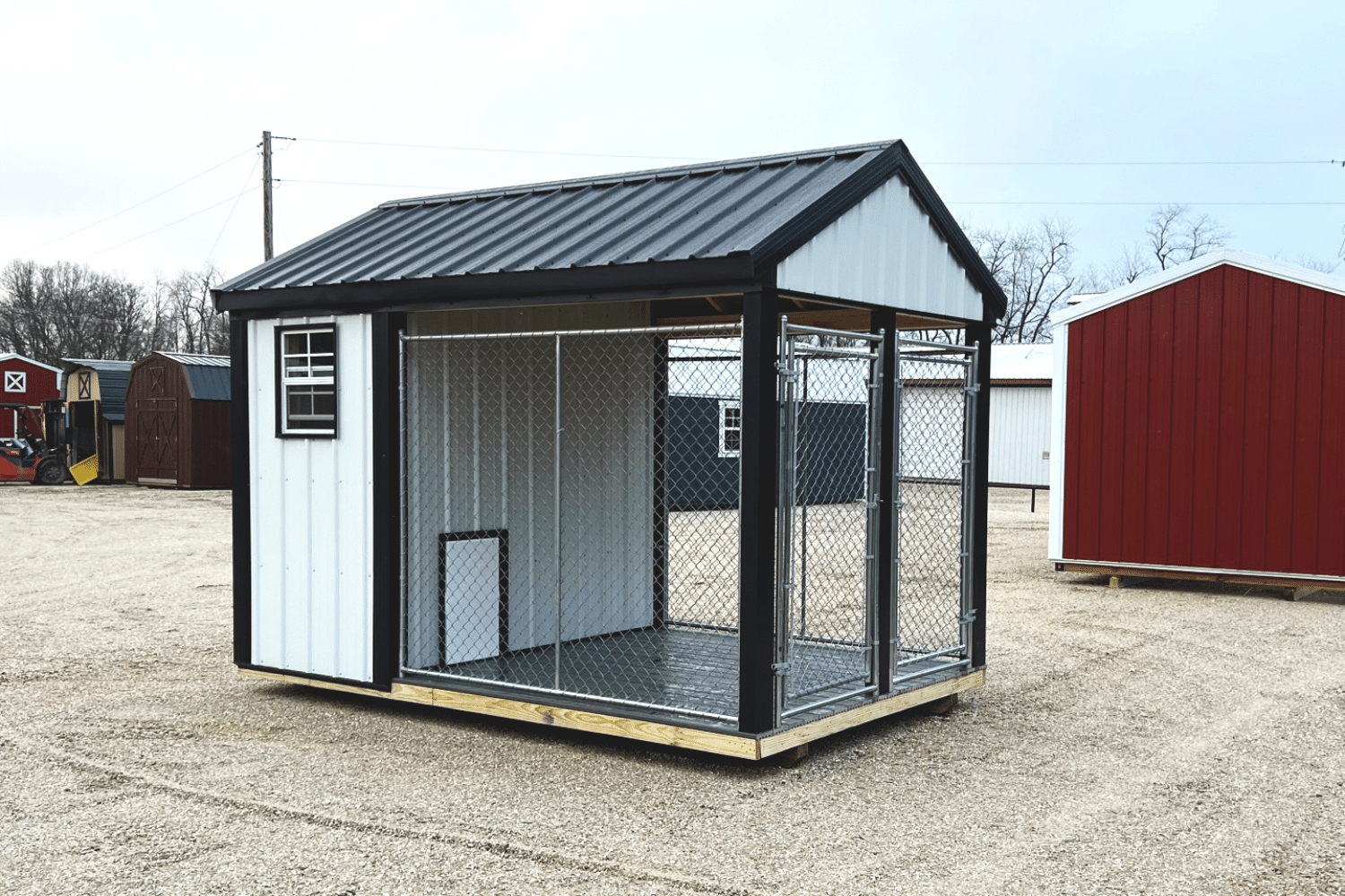 gray and white dog kennel with outdoor run and windows in ellsinore