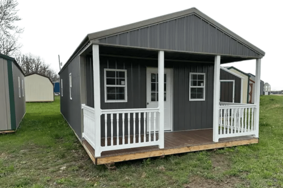 gray cabin with white trim and front porch for sale in Conway, MO